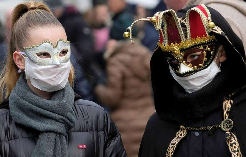 Pareja con antifaces y mascarillas protectoras durante el Carnaval de Venecia/Reuters/Manuel Silvestri.