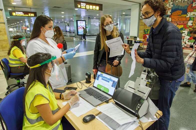 Viajero presentando documentación sanitaria en un aeropuerto/TA: