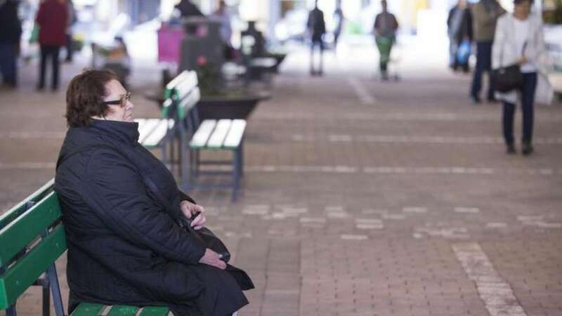Una clienta del mercado descansa en uno de los bancos situados en la zona central. Ahora está casi al aire libre y el frío se hace notar (Foto Borja Suárez/C7)
