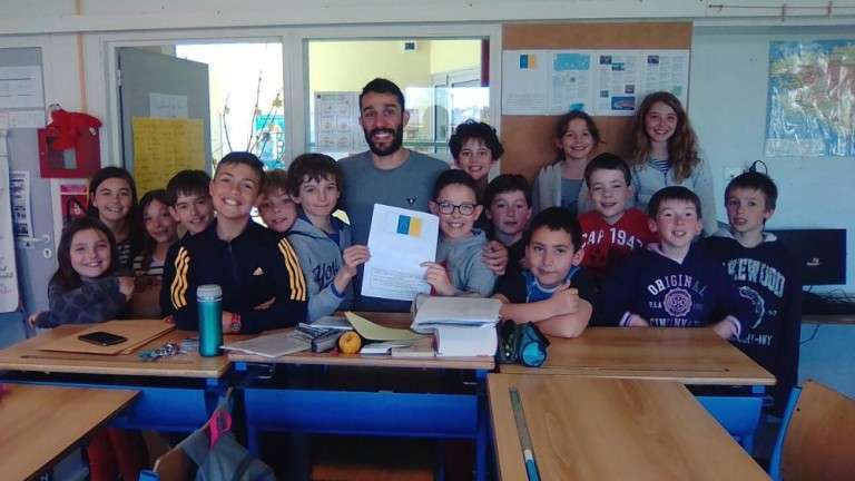 el director con algunos de los alumnos de Primaria del colegio, con la bandera del Archipiélago (Foto Canarias7)