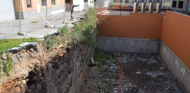 Profundo solar excavado con un vallado metálico casi en el aire (Foto TA)