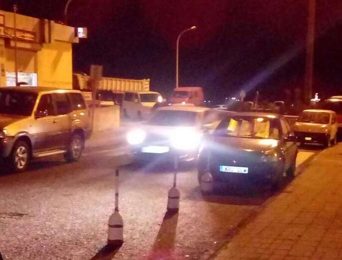 Garrafas a modo de conos para reservar aparcamiento en Jinámar (Foto TA)
