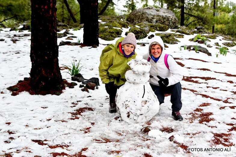 Dos amigas hace un muñeco de nieve en la cumbre/Antonio Alí.