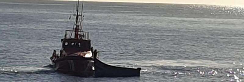 Una embarcación de Salvamento Marítimo junto a una patera (Foto TA)