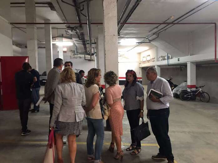 Vecinos y representantes del Gobierno y del Ayuntamiento, en los garajes del complejo residencial (Foto TA)