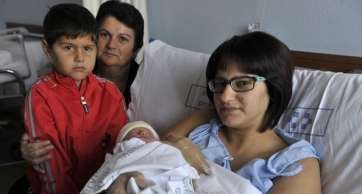 El primer nacimiento fue un parto de gemelas. Una de las gemelas junto a su familia. (Foto Gerardo Montesdeoca-C7)