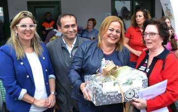 Mari Carmen Castellano hace entrega de una de las cajas de productos sorteadas a la dirigente vecinal 'Chanita' Ruiz (Foto TA)