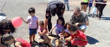 Niños juegan con uno de los perros de la Unidad Canina del CNP (Foto TA)