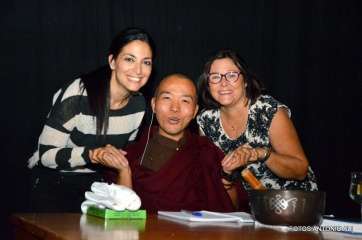 Dos personas que asistieron a la charla posan con el monje budista (Foto TA)