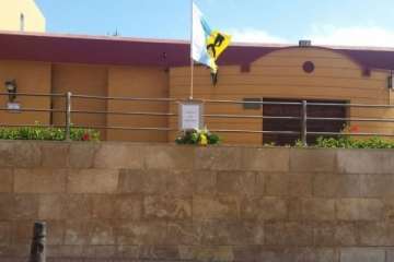 Bandera con crespón negro y cartel en La Garita (Foto TA)