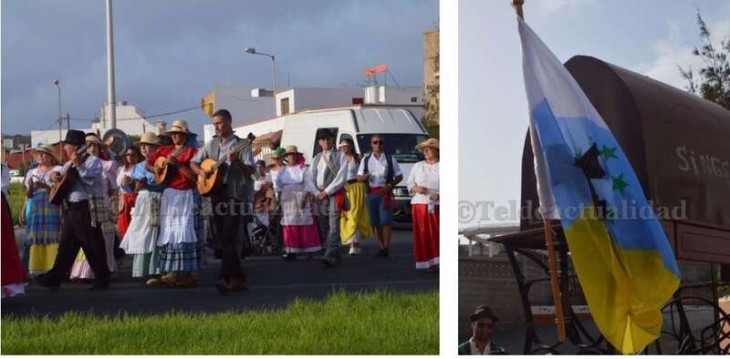Crespón negro en una bandera canaria con siete estrellas verdes y grupo de romeros (Foto TA)