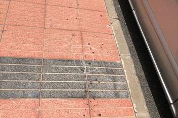 Manchas de sangre en la acera y fachada de un inmueble/TA.